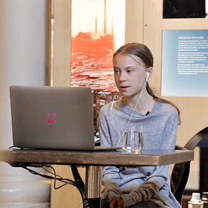 Showing Greta Thunberg, sitting at her computer. Participating in an online interview for Earth Day 2020.